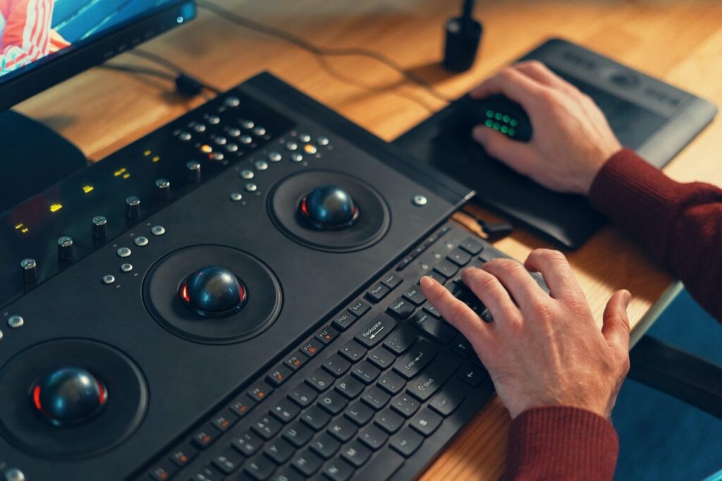 video-editor-hands-adjusting-color-or-sound-on-working-console-machine
